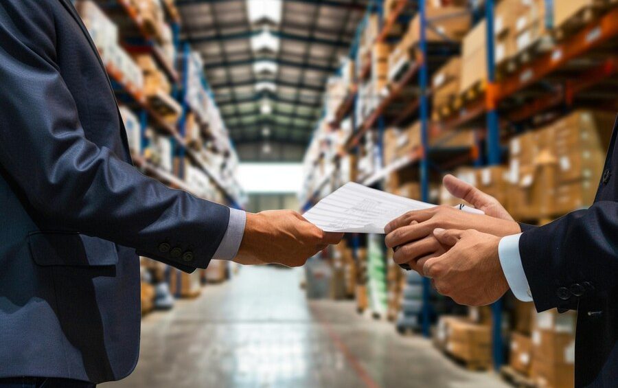 a man handing over a piece of paper to another man