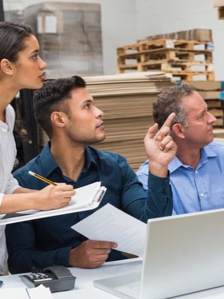 warehouse manager pointing something his colleagues large warehouse 13339 274416 1