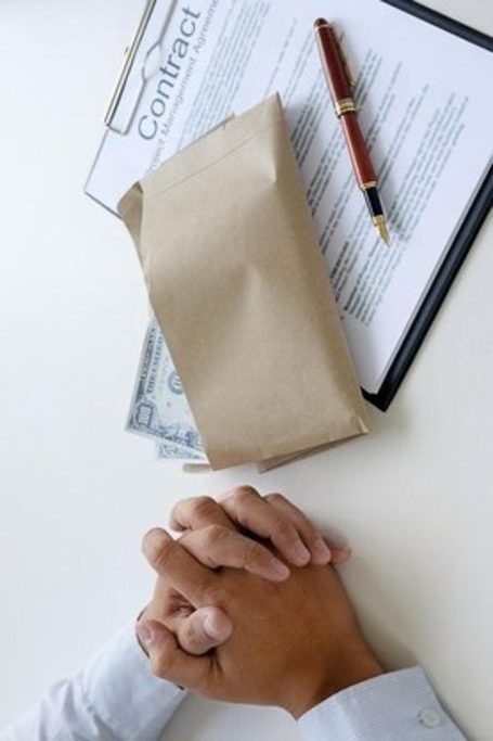 cropped image businessman with hands clasped by money contract form table 1048944 3559258 1 1 rotated